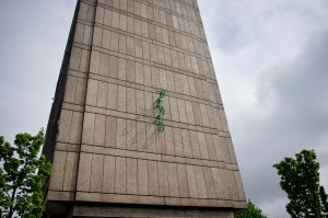 Three green bikes emerge from the wall of Roehampton Library