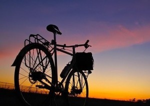 Silhouette of a bike against a sunset sky